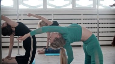 Group of sportive fitness women bending their back backwards