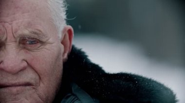 Elderly grandfather - old grandfather is sadly looking at the camera pursing his lips