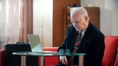 Elderly grandfather - old grandfather taking off his glasses and reloading a gun
