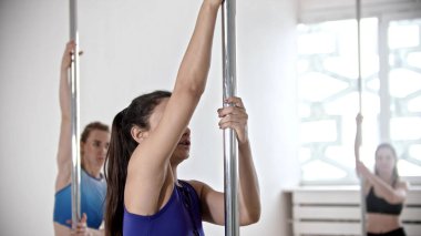 Parlak stüdyoda dans eden genç kadınlar.