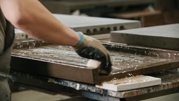 A man worker washing a concrete slab with rag and water — Stockvideo