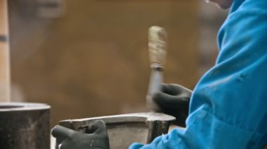 Concrete industry - man worker cleaning the form for concrete casting out from the leftovers in the insides