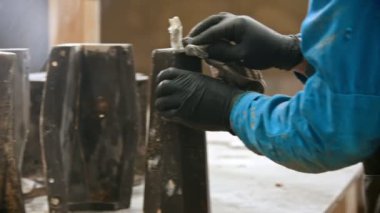 Concrete industry - worker wiping out the black detail after putting it out from the form