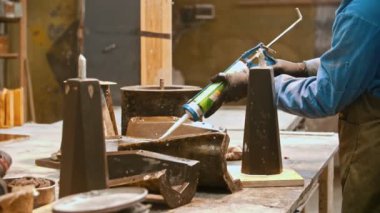 Concrete industry - young man worker applying glue on the detail