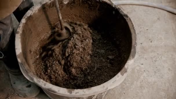 Concrete industry - mixing concrete using a hand mixer — Stock Video