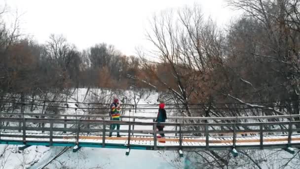 Two colorful women taking photos on the bridge — Wideo stockowe