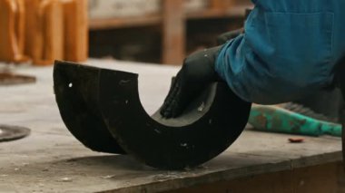 Concrete industry in the workshop - a man working with a chisel to clean up the form