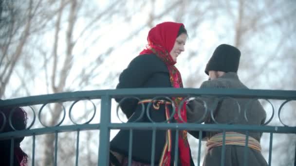 Folklorique russe hommes et femmes russes dansent sur le pont par paires — Video