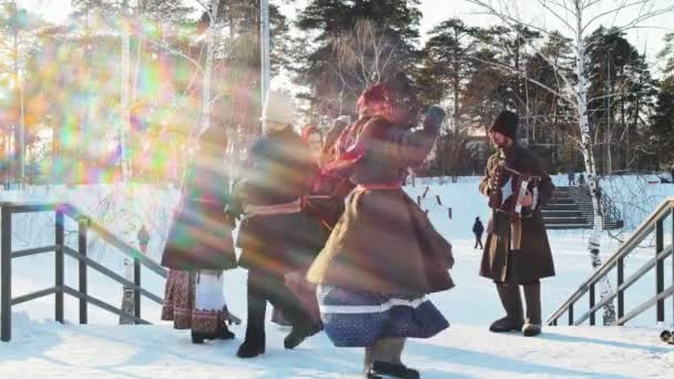 ロシアの民俗-男性と女性は、アコーディオンの音楽に合わせて踊っています — ストック動画