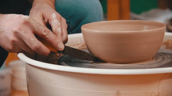 Pottery - the master is helping himself to remove excess clay with a special modeling tool — Φωτογραφία Αρχείου