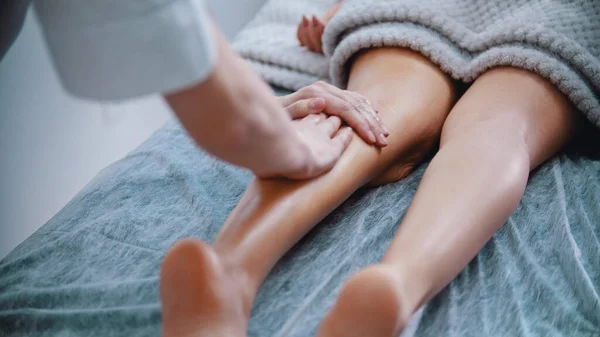 マッサージ – マッサージマスターマッサージ細い足の女性 — ストック写真