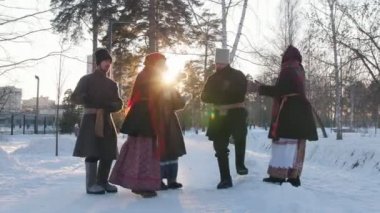 Rus halkı - geleneksel kostümlü bir grup insan bir çember içinde dans edip alkışlıyorlar.