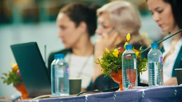 Rhythmic gymnastics tournament - judges sitting by the table and looking at papers — Stock Photo, Image