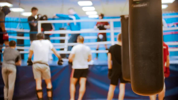 Menschen beim Boxtraining am Ring - im Vordergrund ein Boxsack — Stockfoto