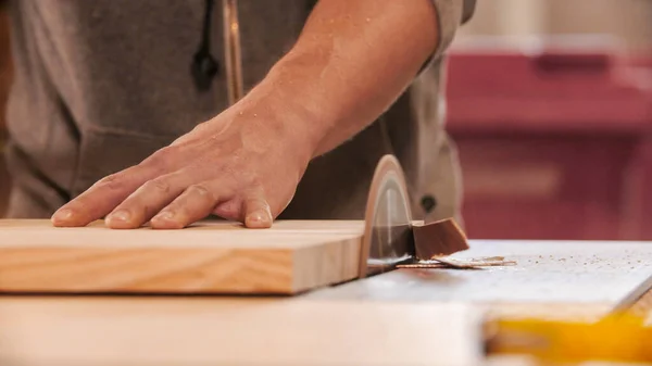 Carpentry industry - cutting out the piece of wood using a circular saw — Stock Photo, Image