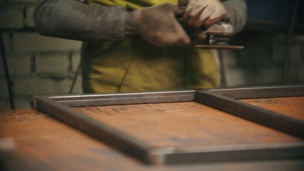 Grinding the seams of metal frame in the workshop - sparkles comes off — Stock Video