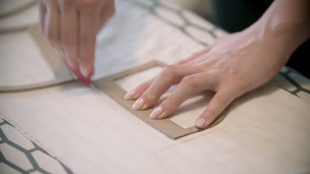 Young seamstress making marks using the soap and different figures and forms — Stock Video