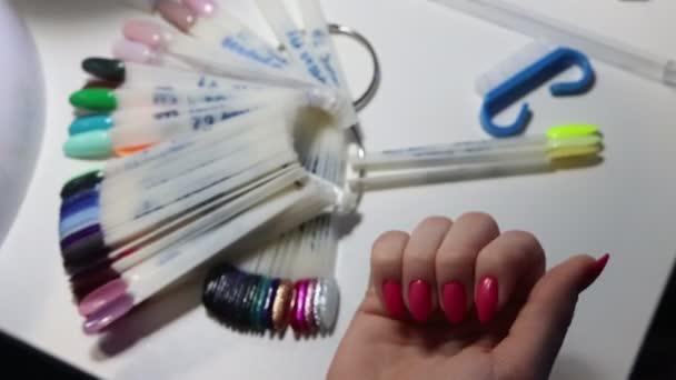 Młoda kobieta patrząc na jej dobrze zrobione różowe paznokcie po manicure — Wideo stockowe