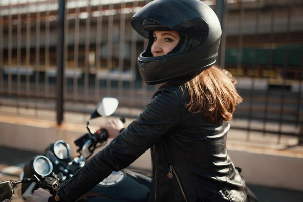 Cute young brunette woman and motorcycle