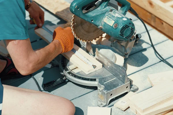 Cutting wooden floor by electric saw in work place