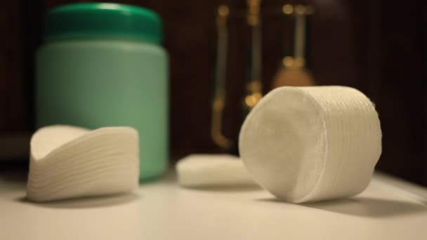 Cotton pads, cream and hands. hands take the disc and dip in the cream. cozy light — Stock Video