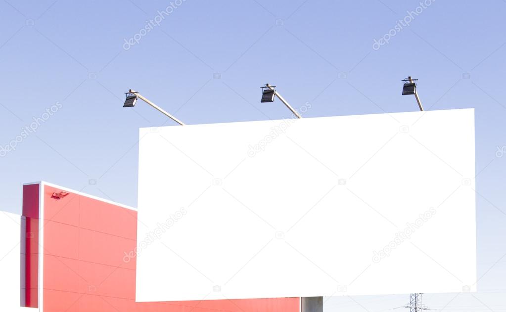 Blank billboard in the city against blue sky