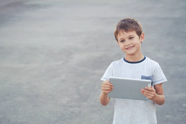 Rapaz sorridente segurar tablet computador. Escola, educação, tecnologia, conceito de lazer — Fotografia de Stock