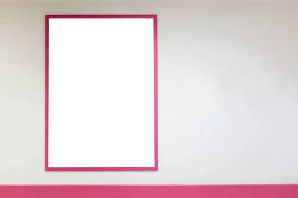 Mock up blank poster frame with pink frames hanging on wall in shopping mill