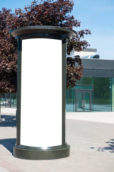 Mock up. Blank outdoor advertising column outdoors, public information board in the street.