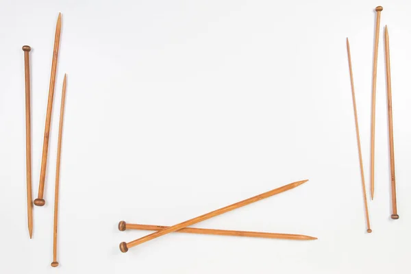 Wooden knitting needles frame with copy space for text on white background — Stock Photo, Image