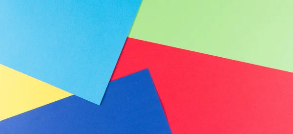 Färg papper geometri platt sammansättning bakgrund med gula, gröna, röda och blå toner — Stockfoto
