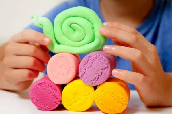 Дитячі руки роблять іграшкову фігуру з моделюванням глини або пластиліну — стокове фото