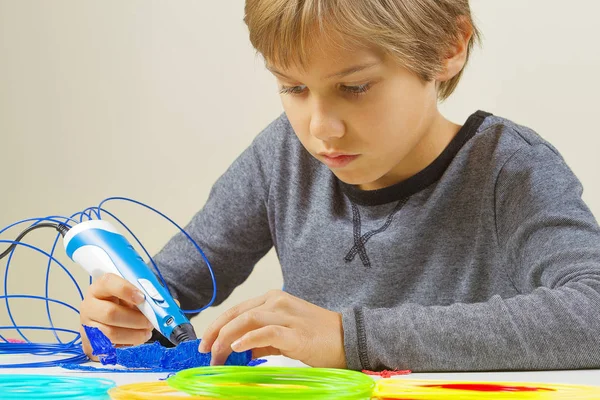 Focused child creating with 3d printing pen — Stock Photo, Image