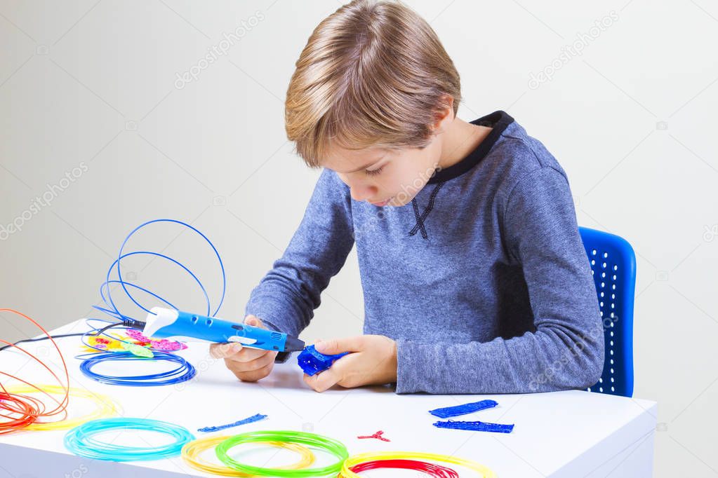Boy creating with 3d printing pen