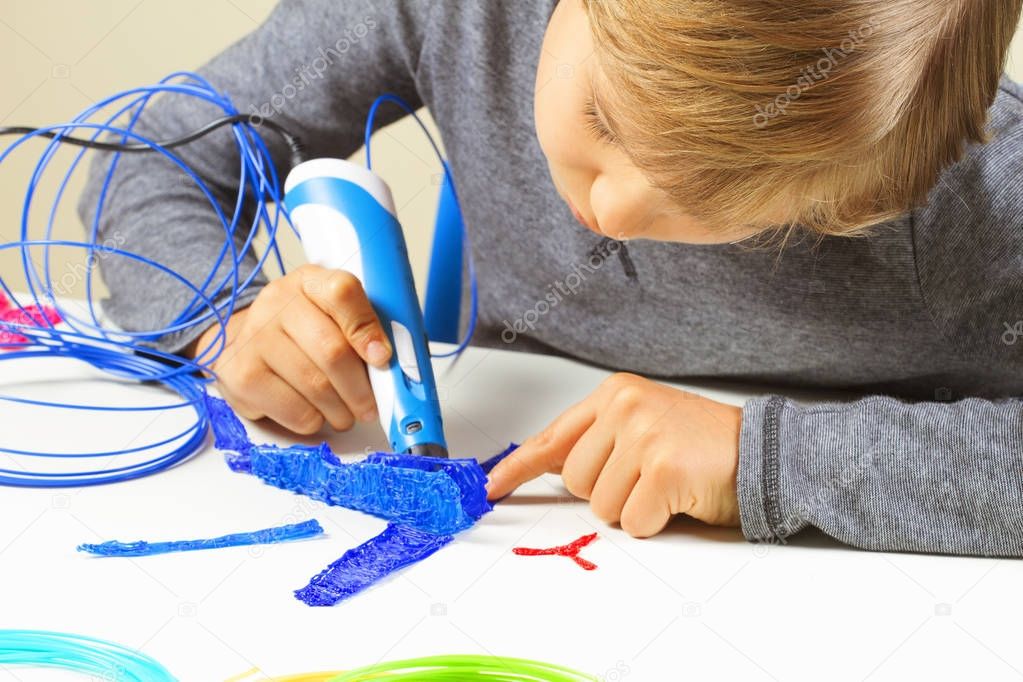 Focused child creating new 3d object with 3d printing pen