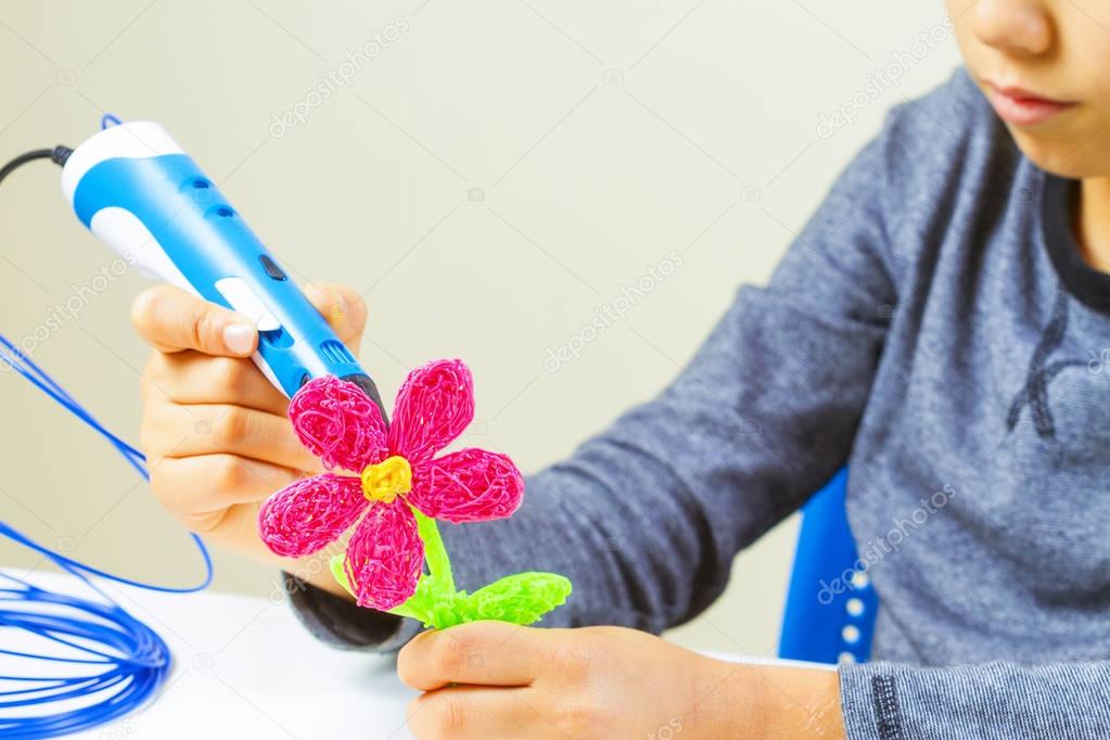 Kids hands making flower with 3d printing pen