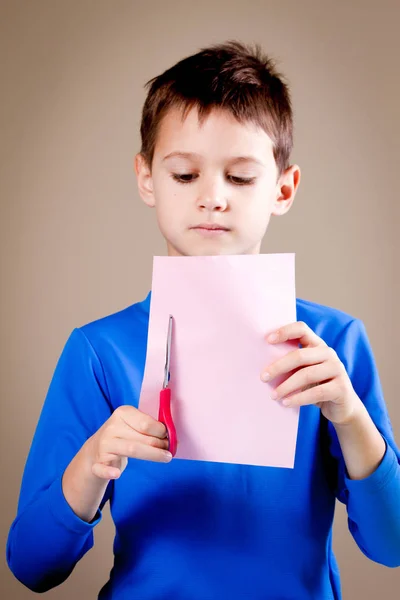 Ragazzo taglio carta colorata con forbici — Foto Stock