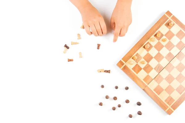 Top view of kid hand and chess board with chess pieces — Stock Photo, Image