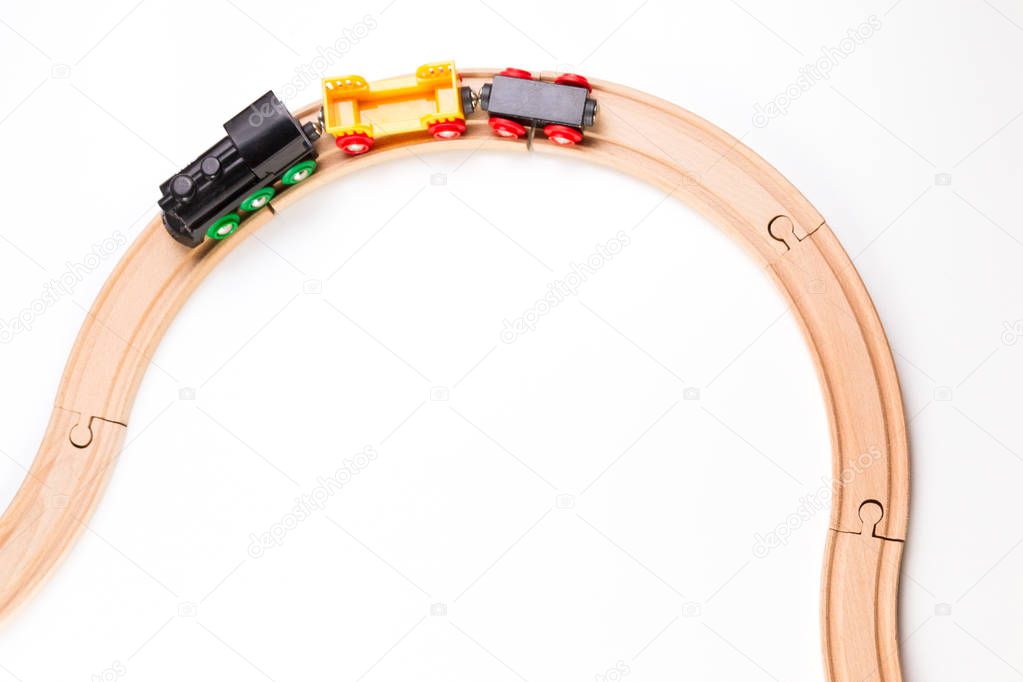 Toy train on curve wooden railways. Top view.