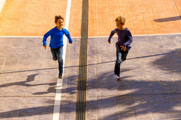 Kids jumping, running outdoor at sunny day