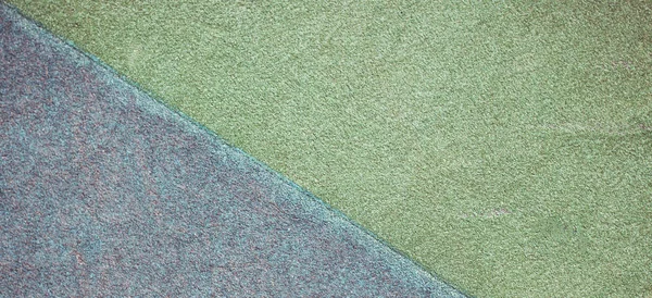 Blue and green playground or sports ground rubber crumb cover grunge background