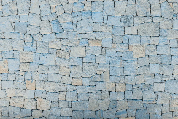 Каменная стена из камней с неровным текстурным фоном — стоковое фото