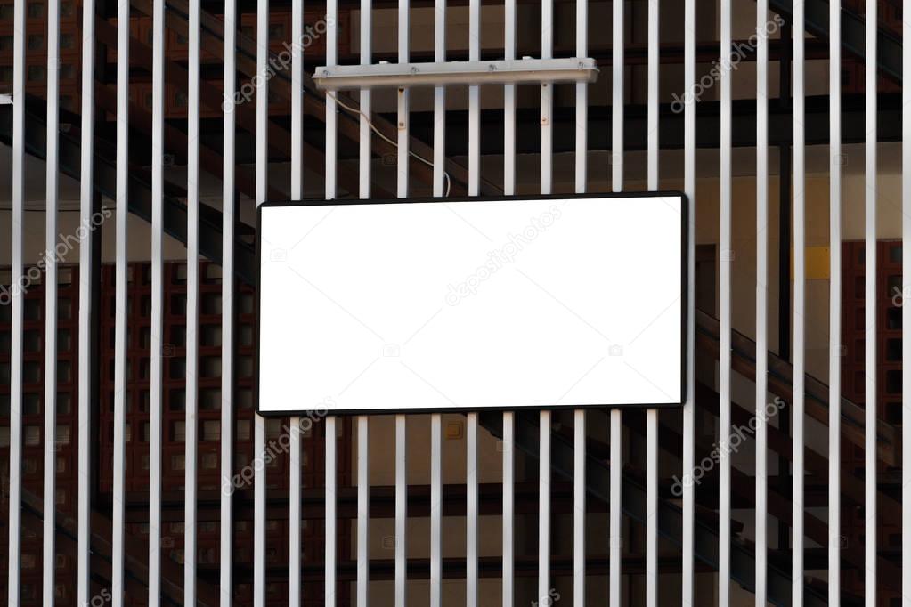 Mock up. Blank information board, signage on a metal fence near industrial building