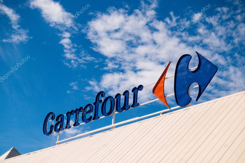 Finestrat, Spain - March 9, 2018: Carrefour logo over blue sky background.