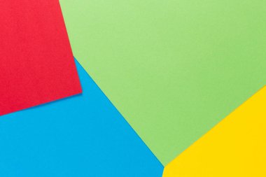 Sarı, yeşil, kırmızı ve mavi tonları ile kağıtları geometri düz kompozisyon arka planını renklendirin