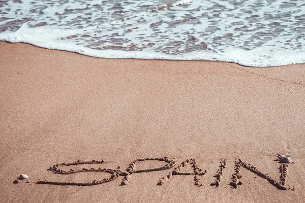 Spanien in den Sand am Strand geschrieben — Stockfoto