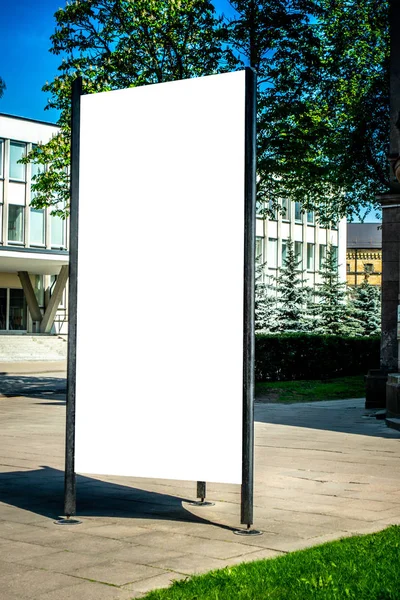 Mock up. Blank outdoor advertising column outdoors, public information board in the city.