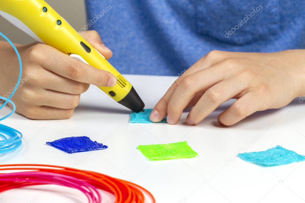 Kid with 3d printing pen creating new item