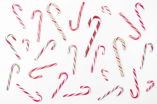 Candy canes pattern on white background. Top view — Stock Photo, Image