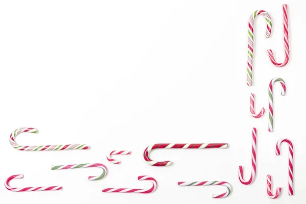 Candy canes border frame on white background. Top view, copy space — 图库照片